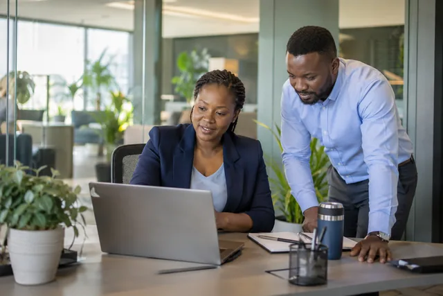 A manager reviewing site activity with a colleague